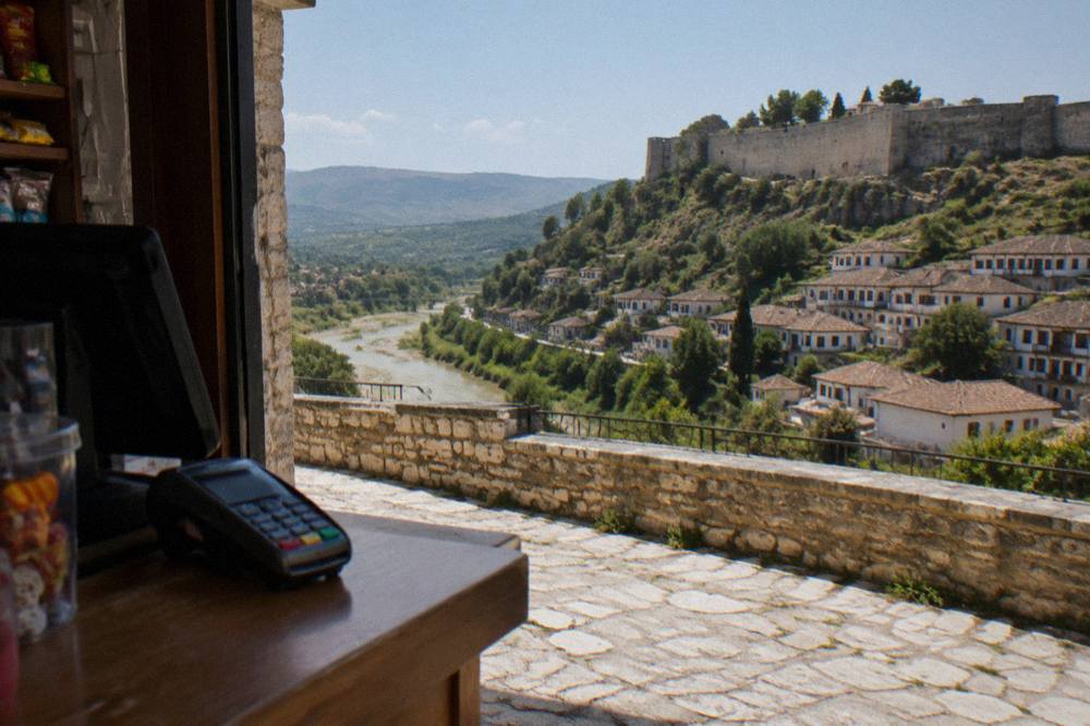 A small shop counter in Berat with a card payment terminal sitting next to the till