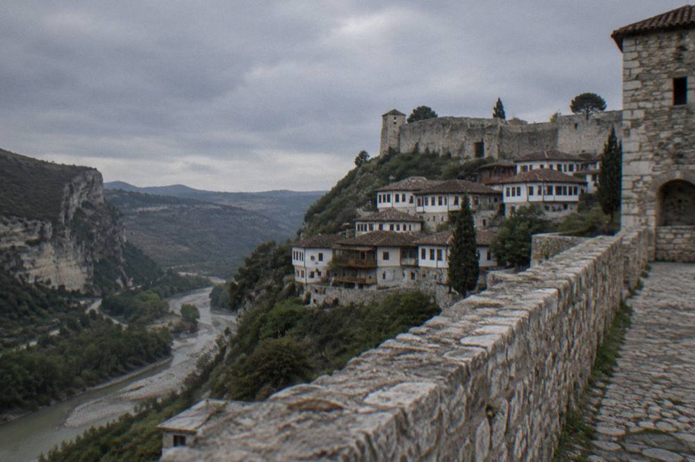 A deep green river canyon with pale limestone walls rising on both sides