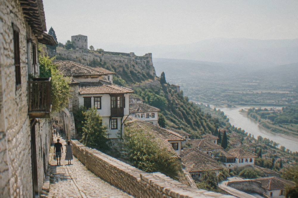 Narrow cobbled street inside the Berat castle quarter with stone walls and old houses