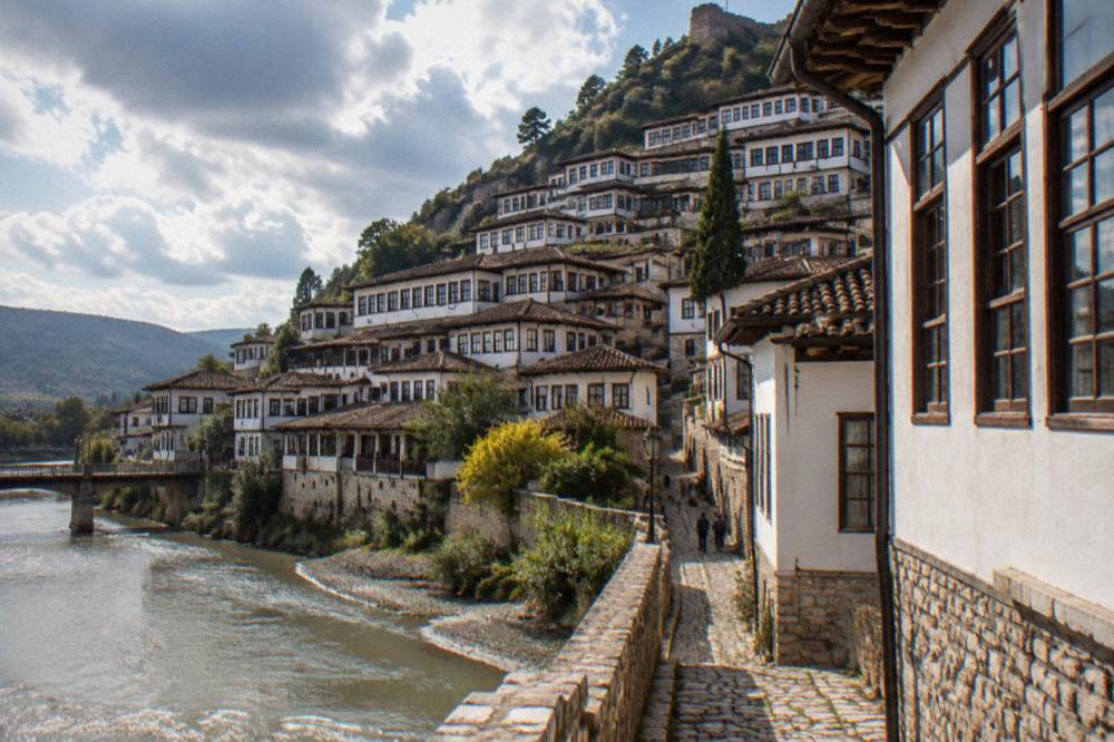 White Ottoman houses of Mangalem stacked on the hillside above the Osum River in Berat
