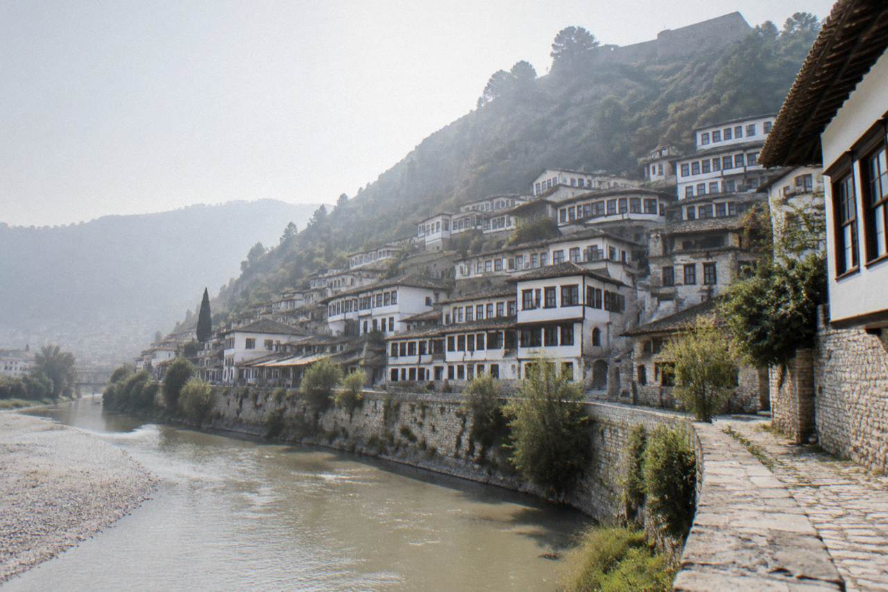 Tiered white Ottoman houses of the Mangalem quarter rising above the Osum River in Berat, Albania