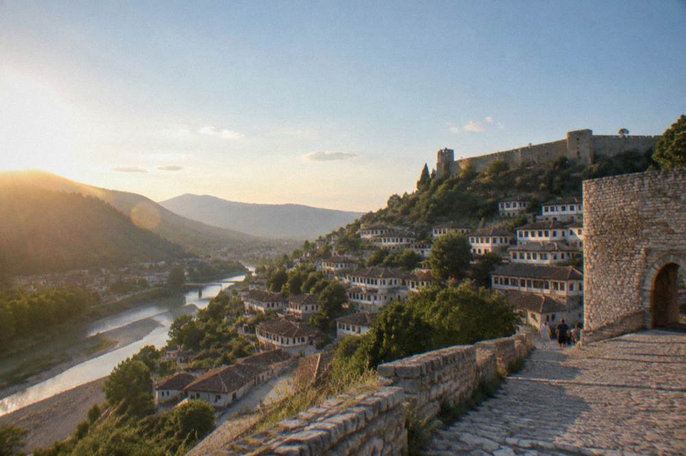 Cobblestone street of white Ottoman houses with wooden windows in Berat old town