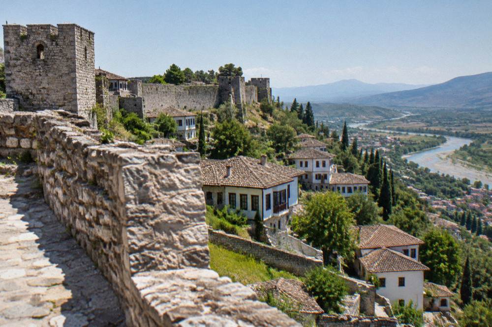 Stone walls and towers of Berat Castle above the old town of Berat in Albania