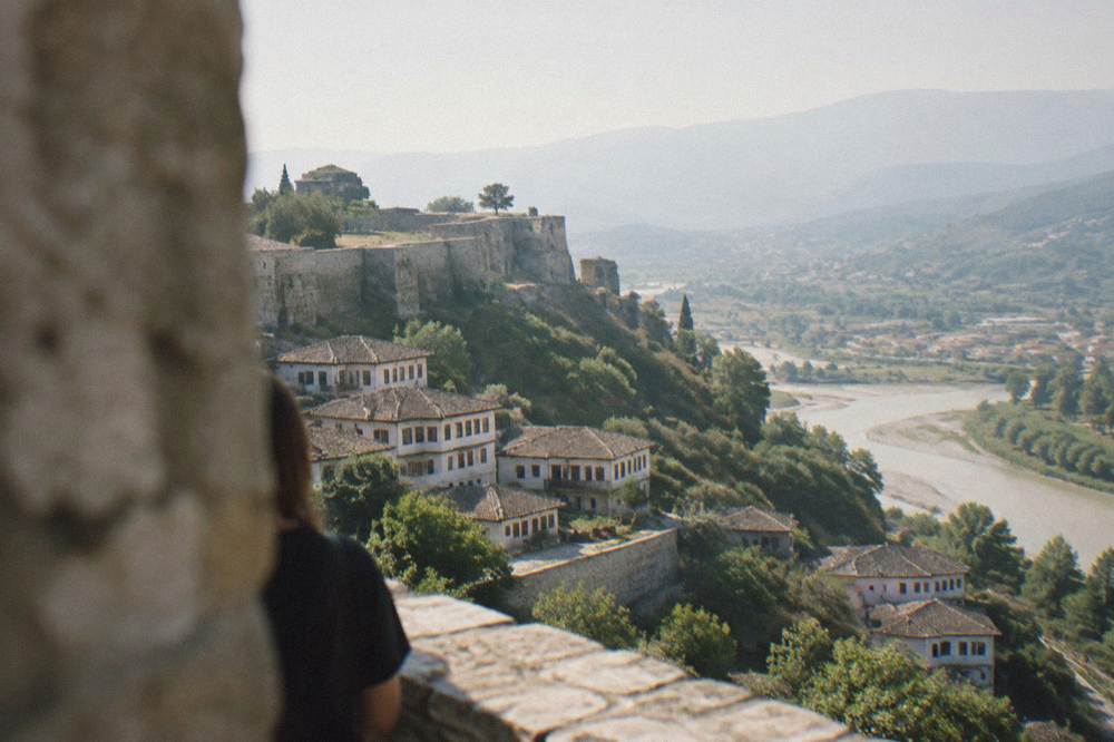 White Ottoman houses stacked on a hillside above a river town
