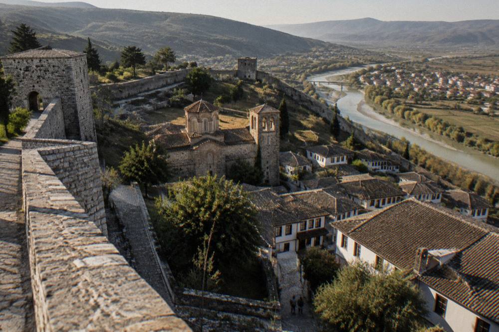 Stone walls and church towers inside the hilltop castle quarter of Berat
