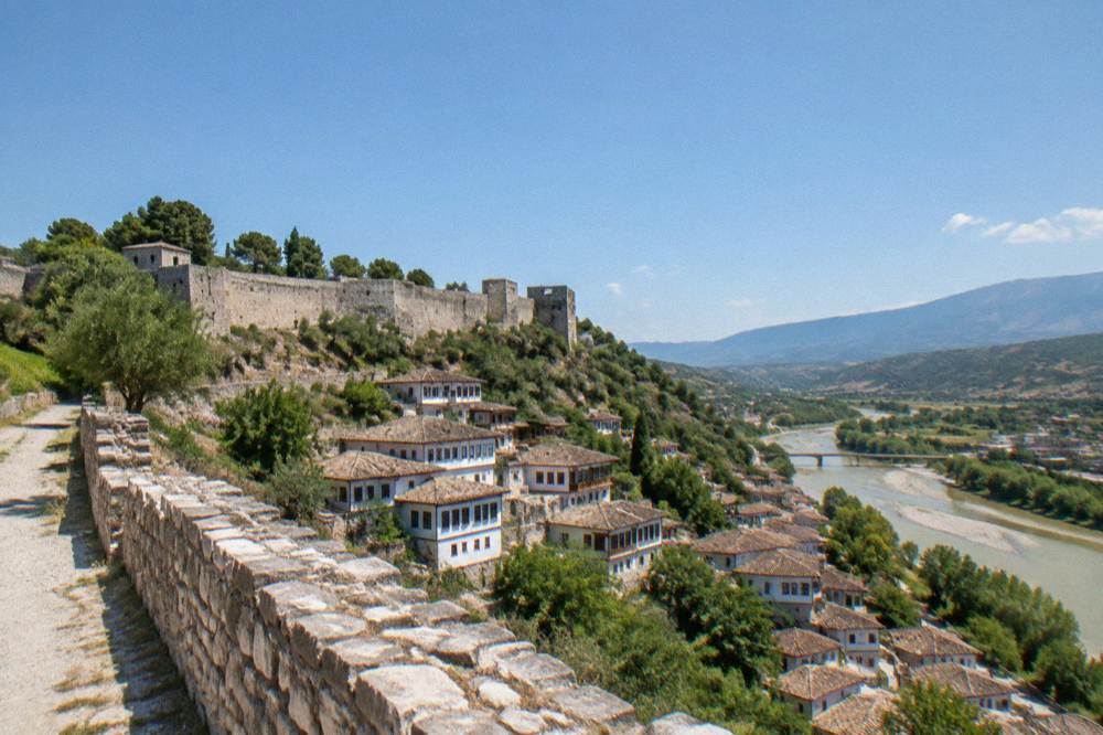 White Ottoman houses stacked on a hillside above the Osum River in Berat