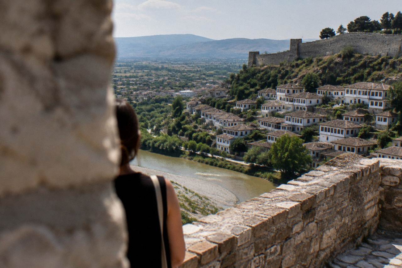 White Ottoman houses stacked on a hillside above the Osum River in Berat, Albania