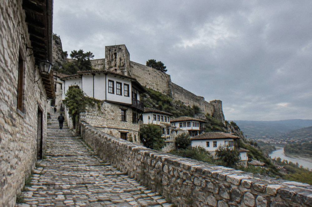 Narrow cobbled lane inside a walled fortress quarter with stone houses