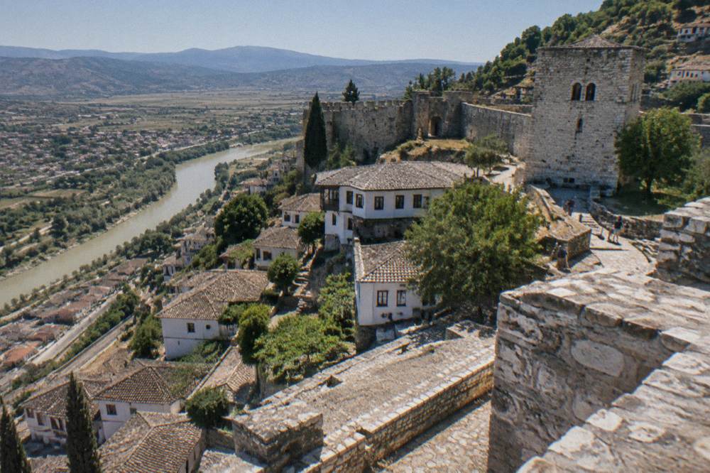 Whitewashed houses and a stone tower inside a walled hilltop quarter