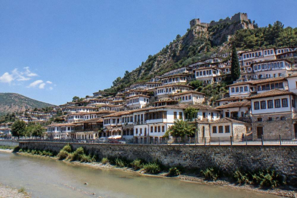 White Ottoman-era houses of Mangalem rising above the Osum River in Berat