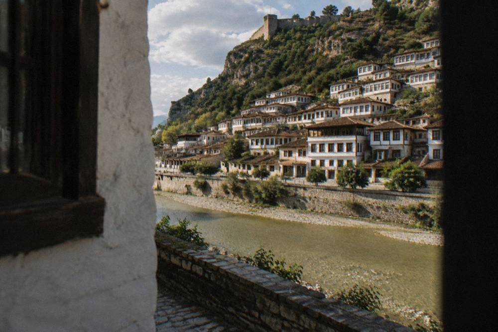 Whitewashed houses of the Mangalem quarter climbing a hillside above the Osum River in Berat
