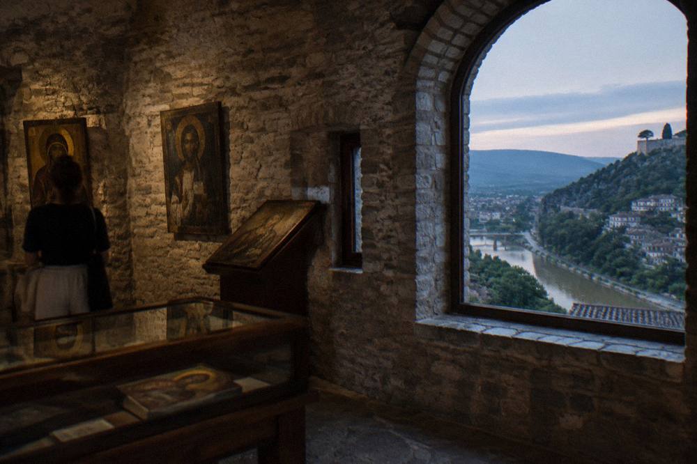 Museum interior with historic icons displayed in a restored stone building in Berat