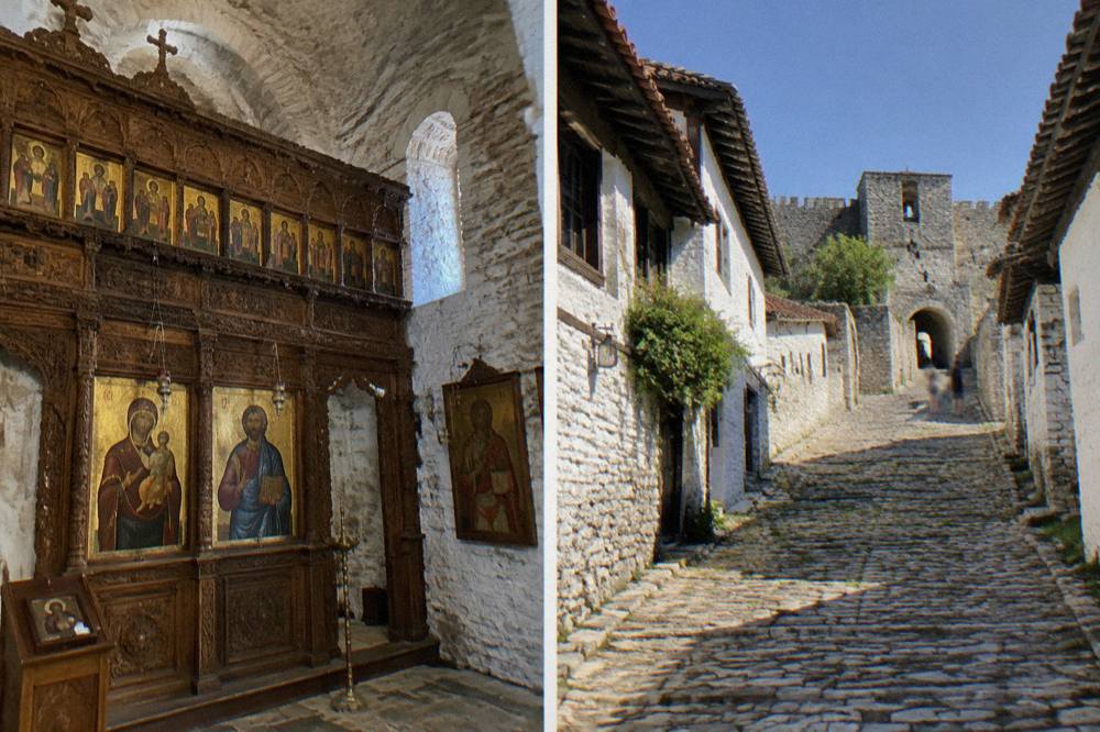 Steep stone lane climbing between whitewashed Ottoman houses toward a castle gate