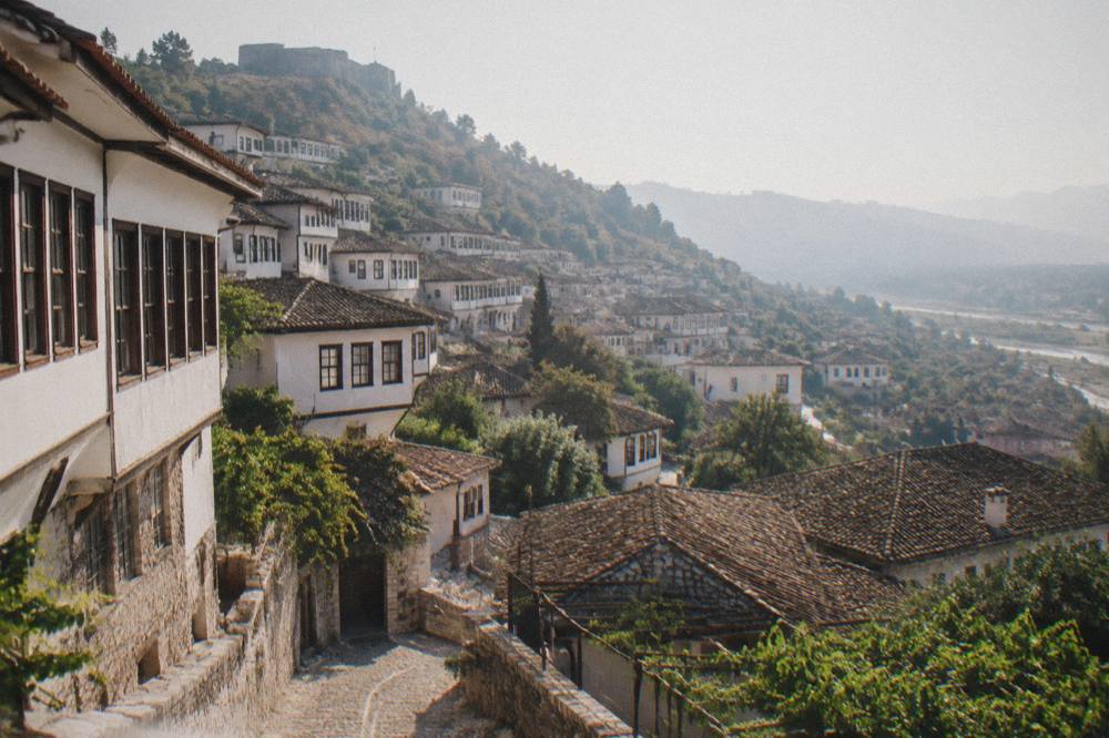 Whitewashed Ottoman houses of the Mangalem quarter stacked on the hillside below the castle