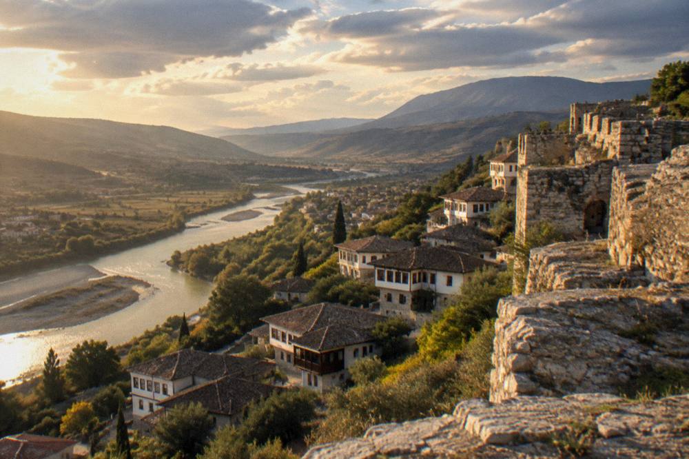 View across the Osum valley from the walls of Berat Castle at golden hour