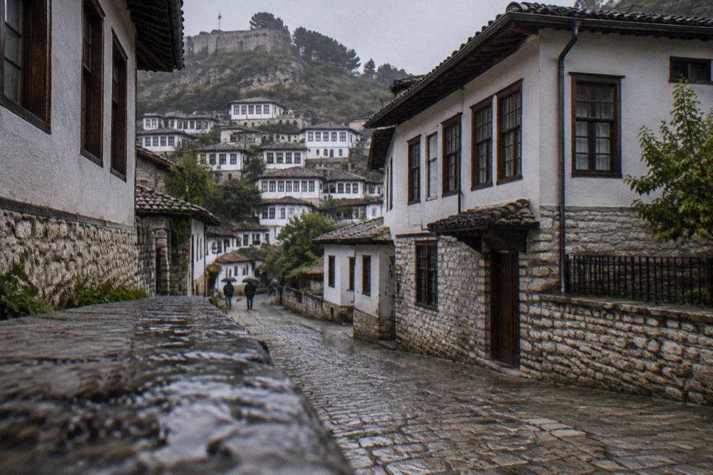 A narrow cobbled lane in Mangalem lined with white Ottoman houses