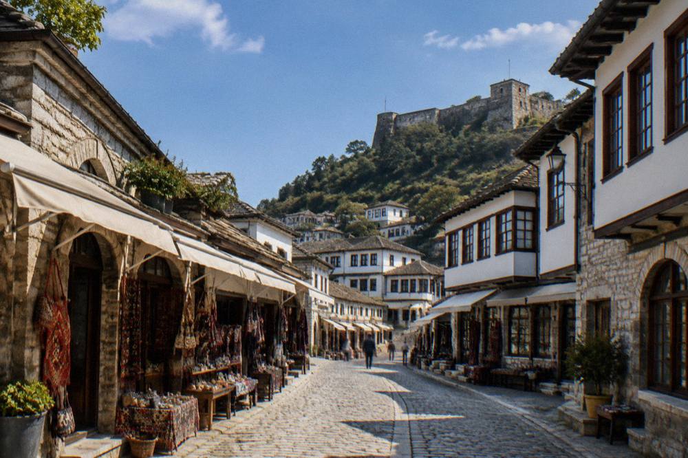 A narrow stone lane in Berat's old town lined with white Ottoman houses with large windows