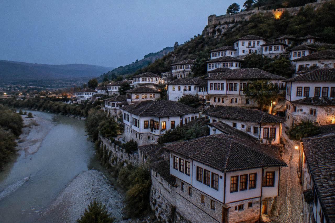 The white Ottoman houses of Mangalem stacked on the hillside above the Osum River in Berat