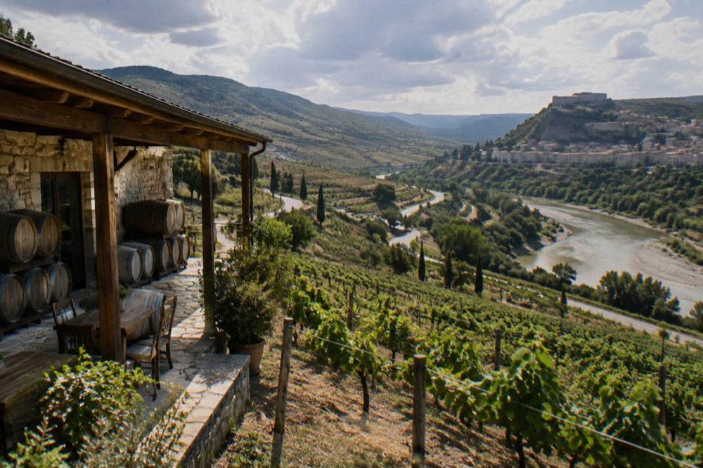 A country road winding through vineyards and hills toward Berat in central Albania
