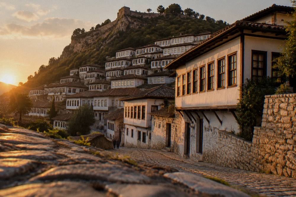 Twilight over the white Ottoman houses of Mangalem lit against the hillside in Berat