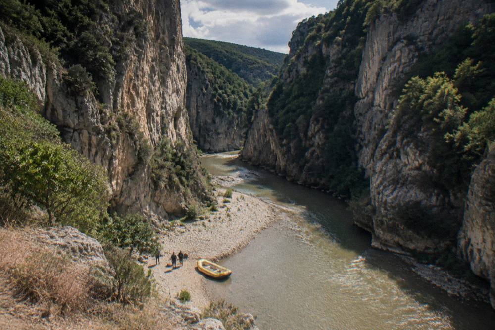 View from a canyon rim overlook across the winding Osum river gorge
