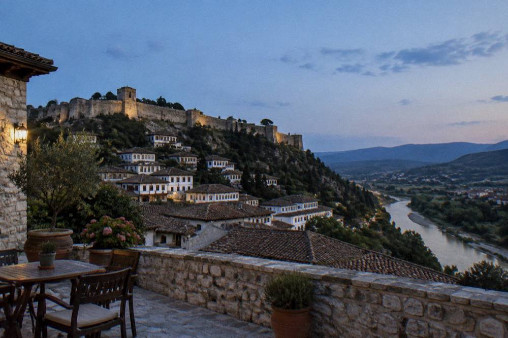 Stone guesthouse terrace in Berat with a level courtyard and views over the tiled rooftops