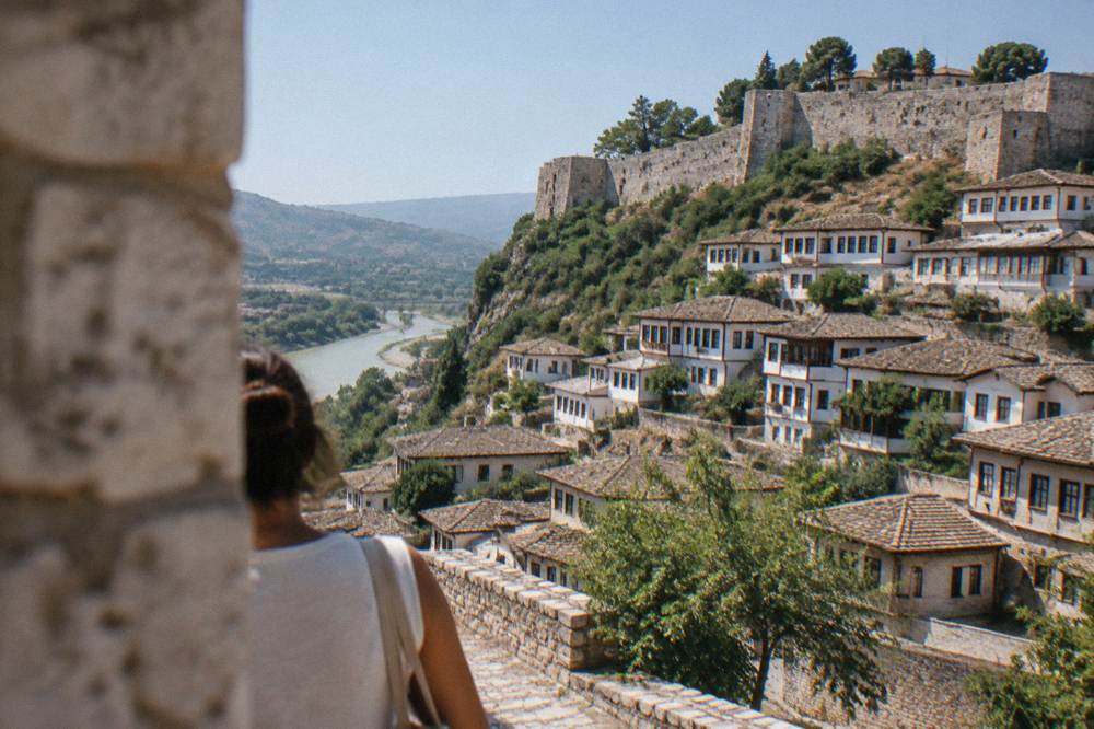 Row of white Ottoman houses with many windows on a hillside in Berat