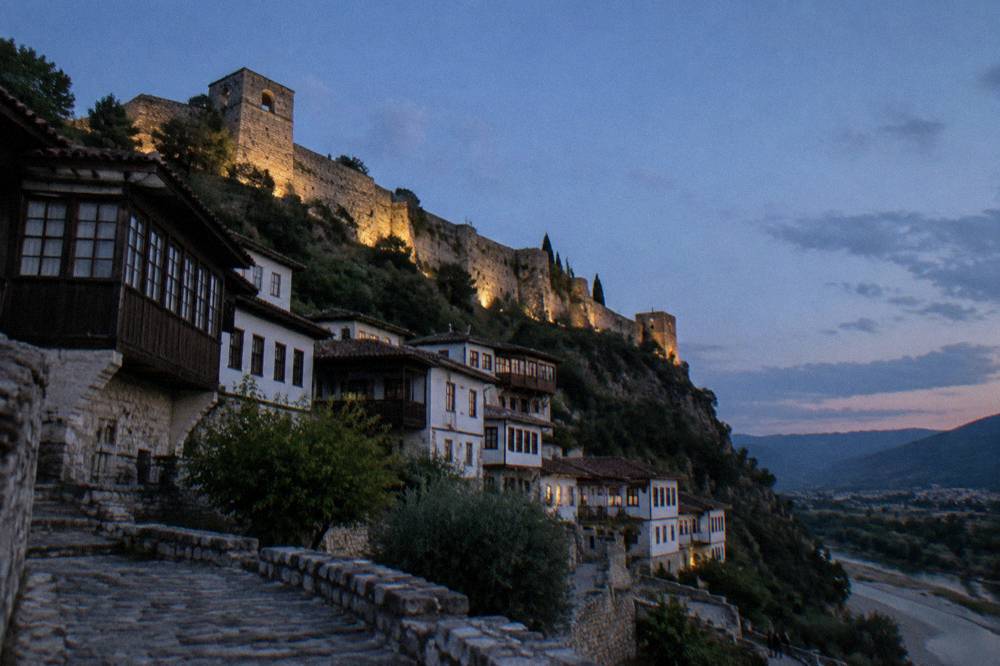 Stone castle walls and towers above the rooftops of Berat