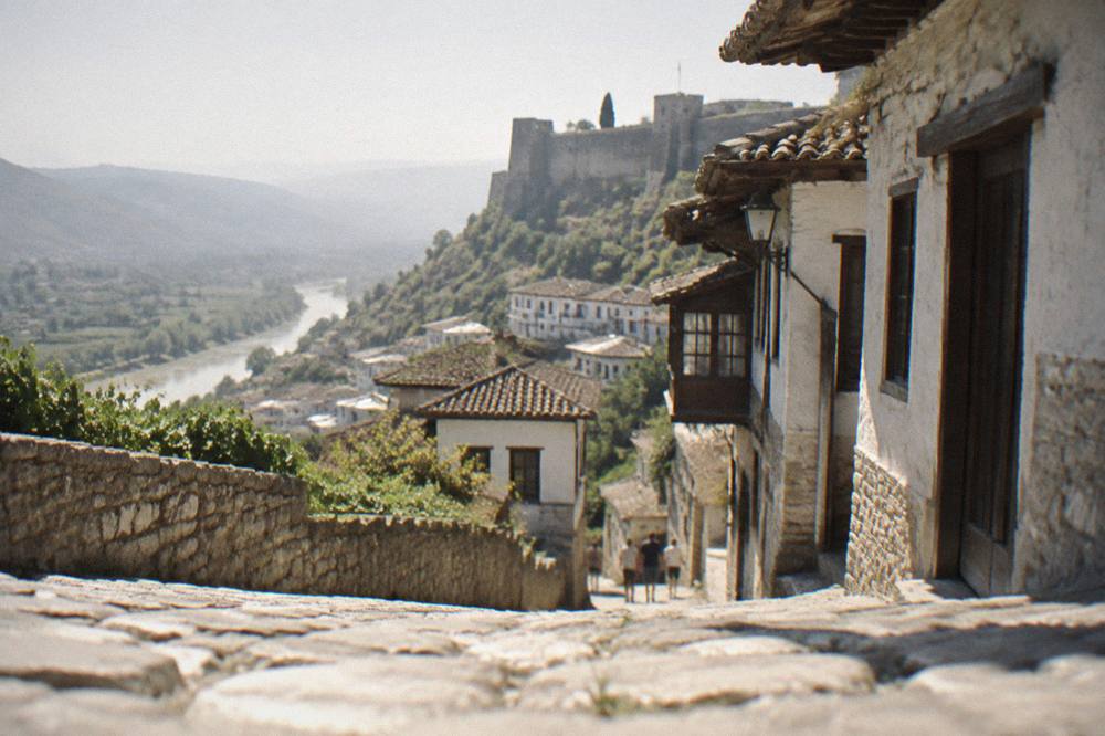 Restored historic street with stone pavement and traditional houses in Berat