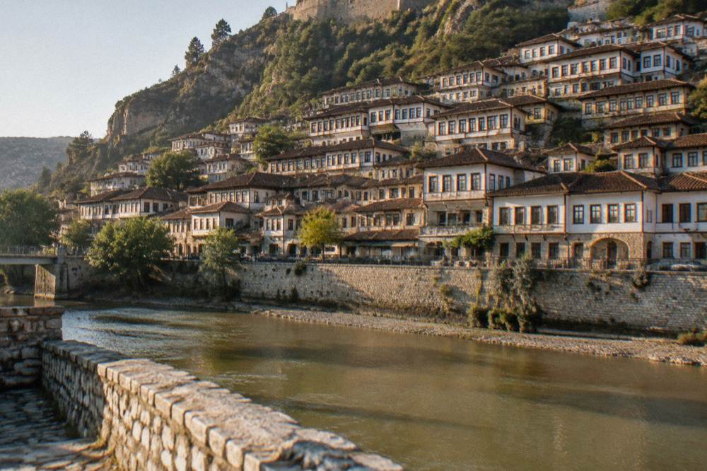 Berat's Mangalem quarter seen across the Osum River, rows of Ottoman houses climbing the hillside