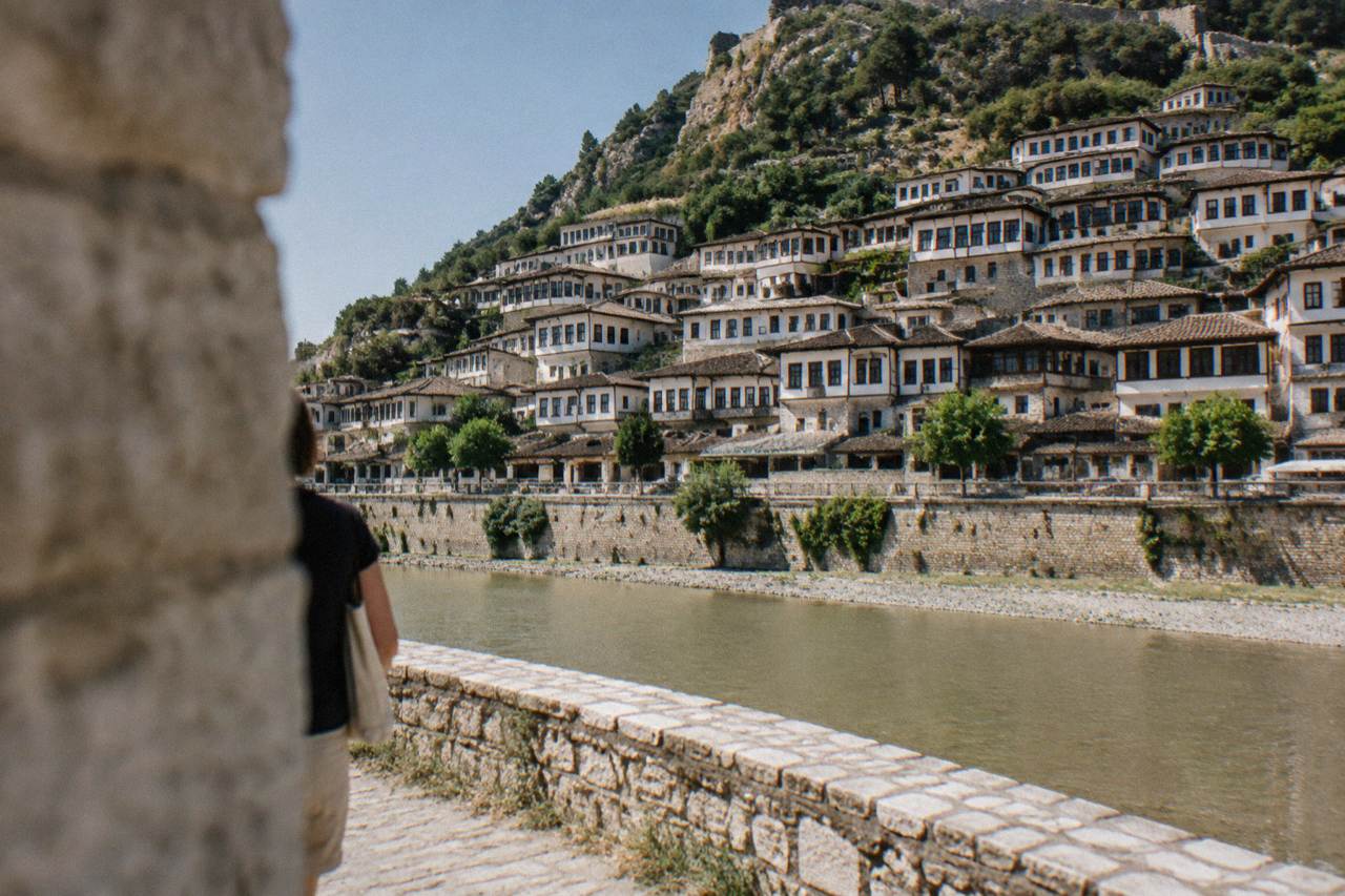 Berat's Mangalem quarter seen across the Osum River, rows of Ottoman houses climbing the hillside