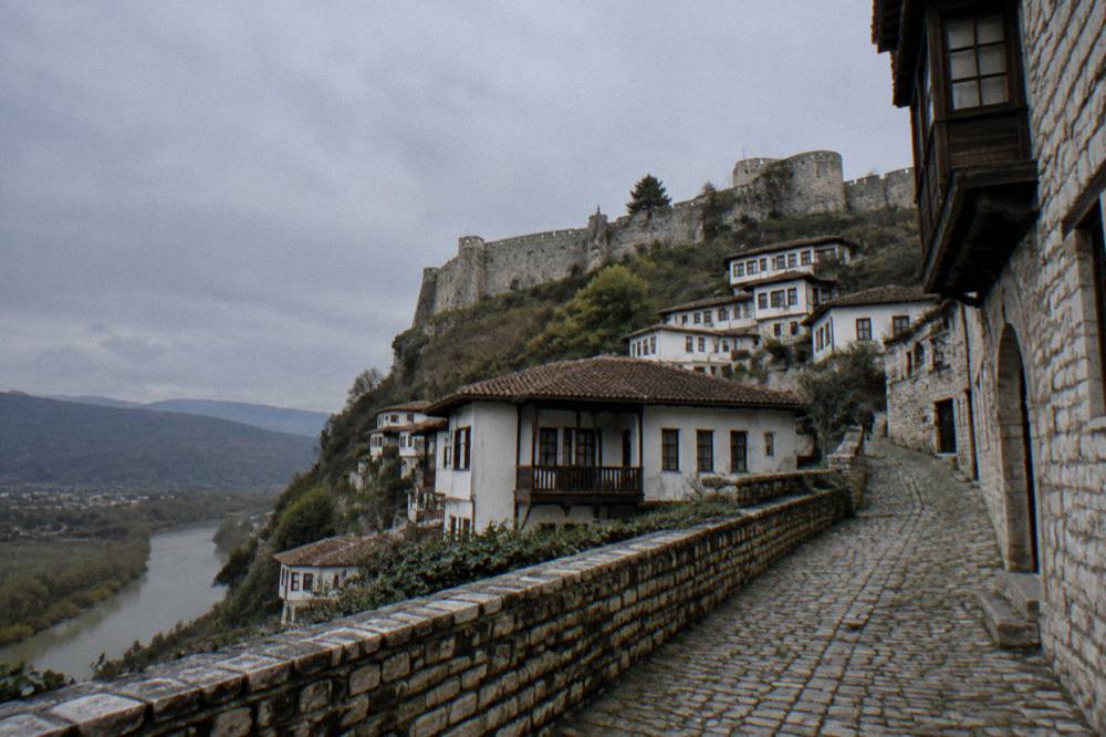 Narrow cobbled street inside the old quarters of Berat lined with stone houses