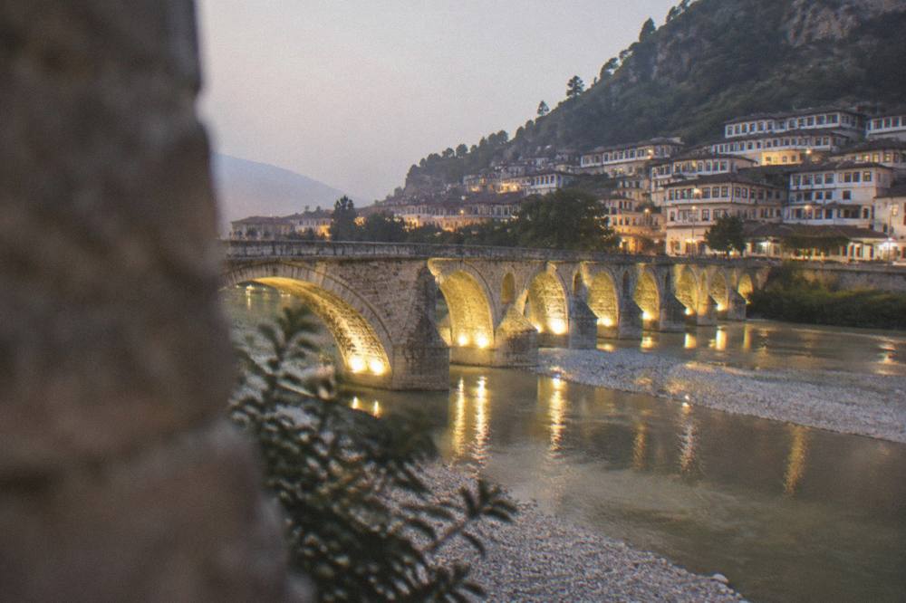 Lit Gorica Bridge spanning the Osum River at night in Berat, Albania