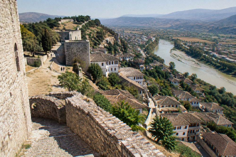 White Ottoman houses stacked on a hillside above the Osum River in Berat