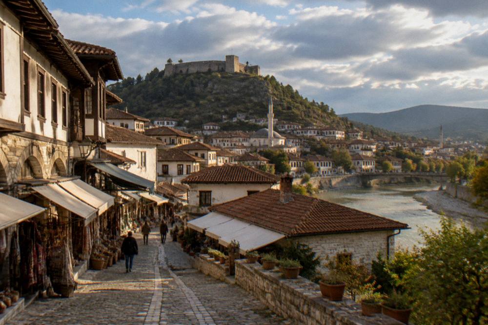 Evening light over the red rooftops and minarets of Berat old town from above the river