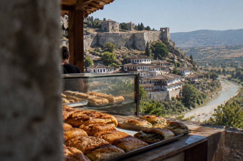 Bakery counter with freshly baked savoury pastries on display in Berat