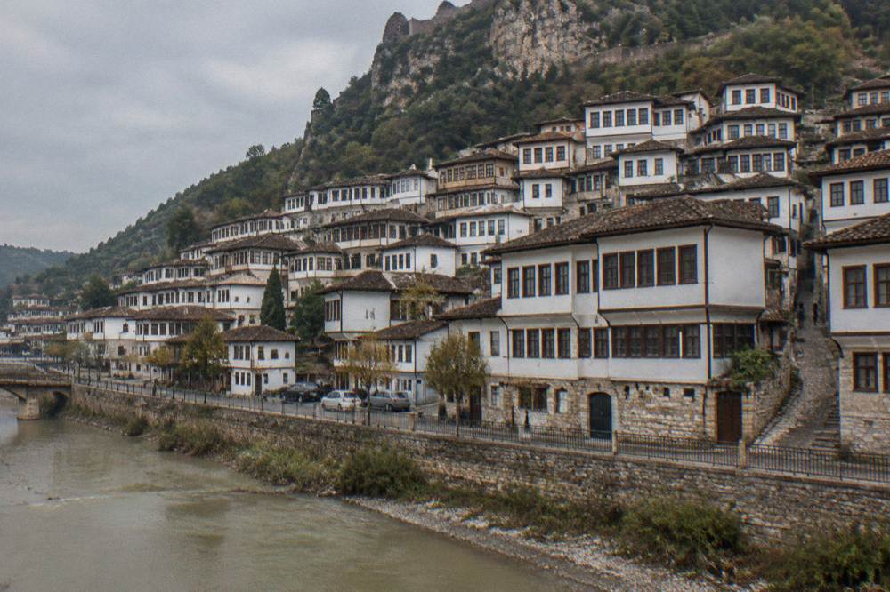 White Ottoman houses of Mangalem stacked on the hillside above the Osum River in Berat
