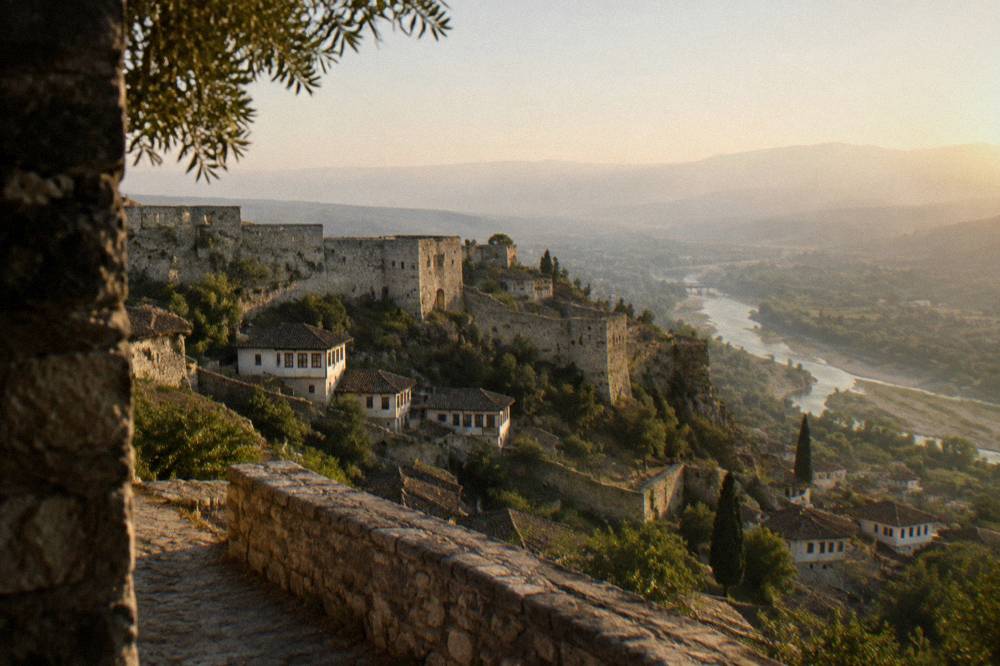 Berat Castle walls and the Osum River valley seen from the hilltop at golden hour