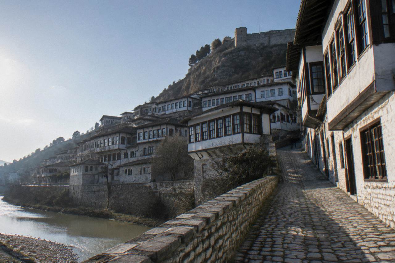 White Ottoman houses of Mangalem stacked on the hillside above the Osum River in Berat