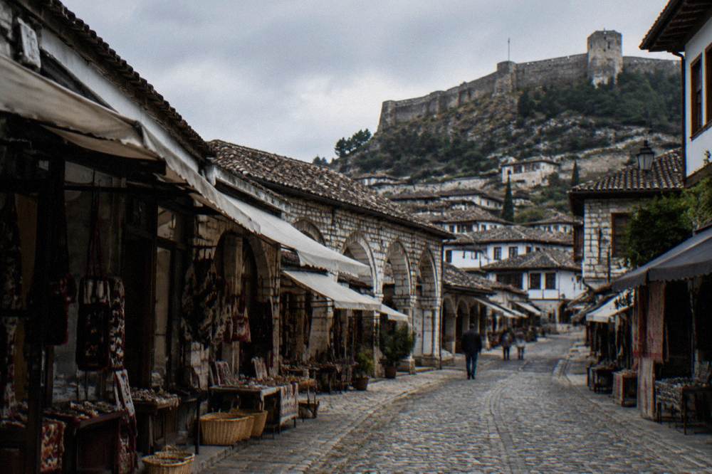 Stone castle walls above the tiled rooftops of Berat old town