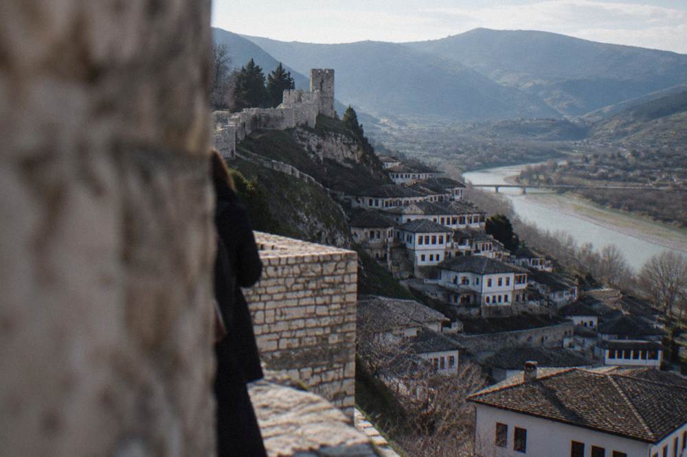 White Ottoman houses stacked on a hillside above the Osum River in Berat