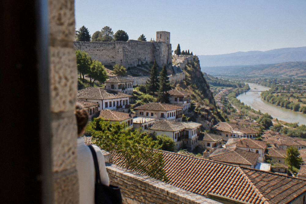 Terracotta rooftops of Berat under morning light with the castle above