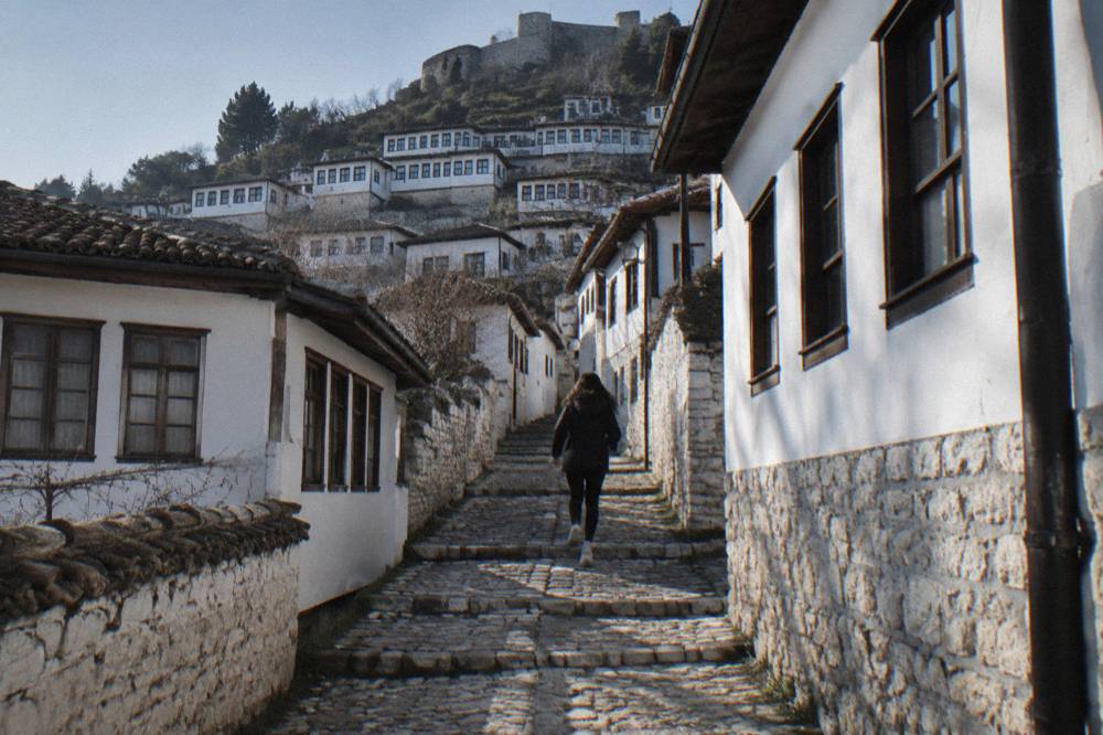 Stone steps winding between whitewashed houses in the Mangalem quarter of Berat