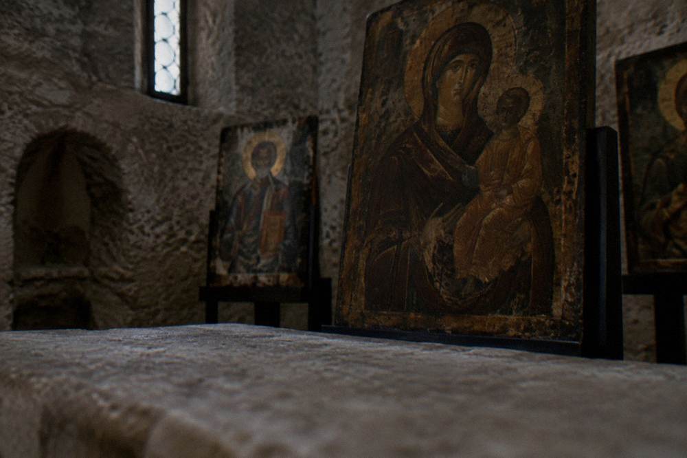 Byzantine icons displayed in a dim museum interior inside an old church